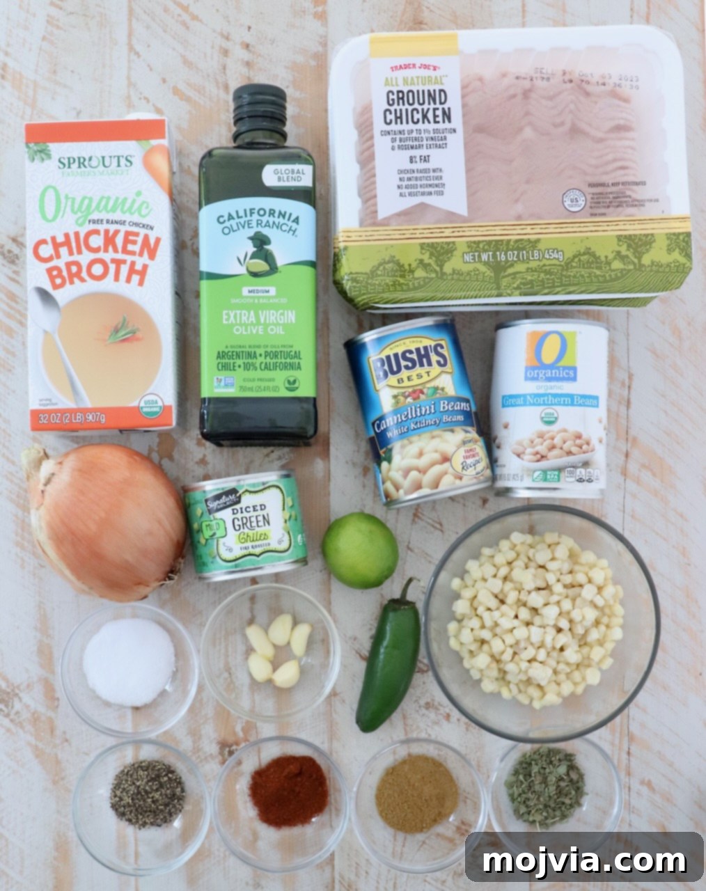 Homestyle White Chicken Chili 3 A flat lay photograph of all ingredients for white chicken chili arranged on a white wooden board