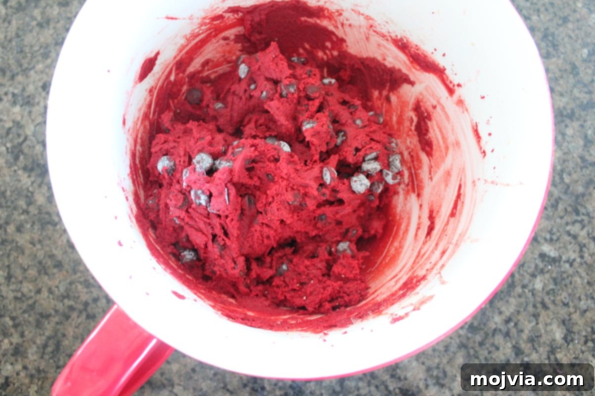 Ruby Red Brookie Bliss 6 Red velvet chocolate chip cookie dough mixed in a bowl, with visible chocolate chips.