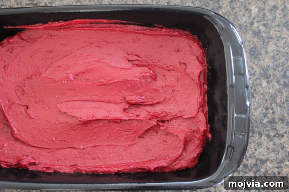 Ruby Red Brookie Bliss 8 Smooth red velvet brownie batter spread evenly in the bottom of a baking dish.