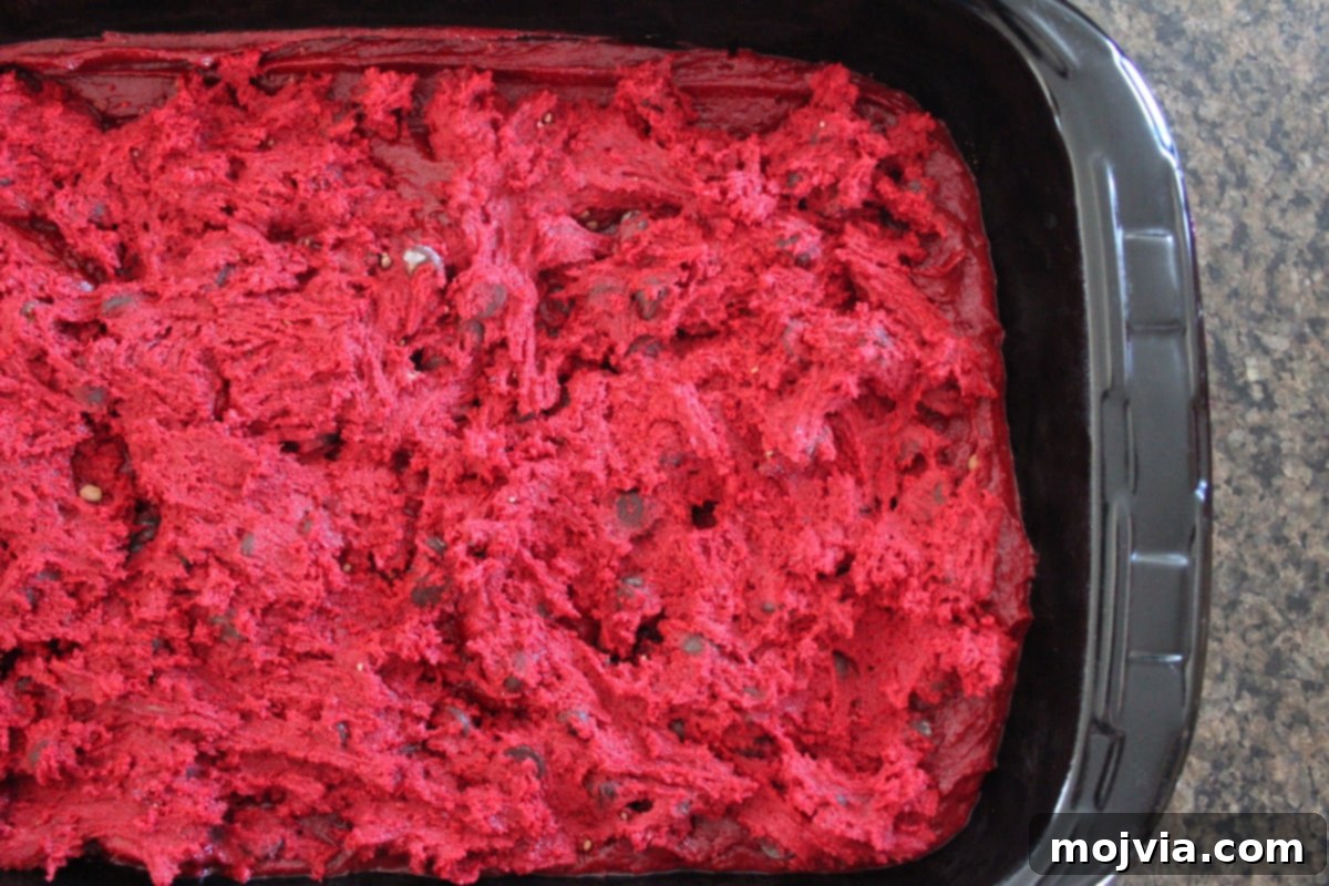 Ruby Red Brookie Bliss 9 Red velvet brownie batter generously topped with dollops of red velvet cookie dough in a baking dish.