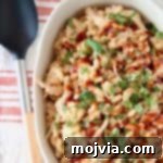 Smoky BBQ Chicken Mac Bake 4 Mac and cheese topped with bbq sauce and cilantro in oval casserole dish