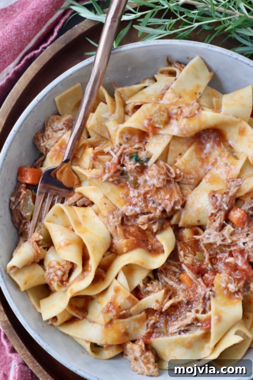 Braised Pork Ragu 2 pork ragu sauce tossed with pappardelle noodles in bowl with fork