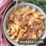 Braised Pork Ragu 13 braised pork ragu tossed with cooked pasta in bowl with fork