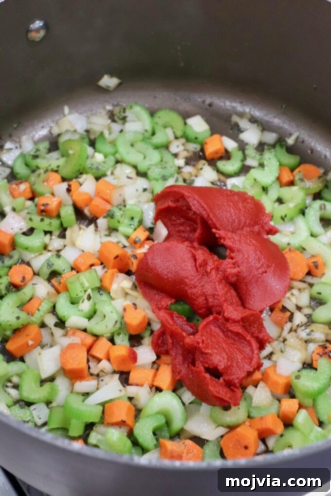 Braised Pork Ragu 6 diced vegetables in pot with tomato paste