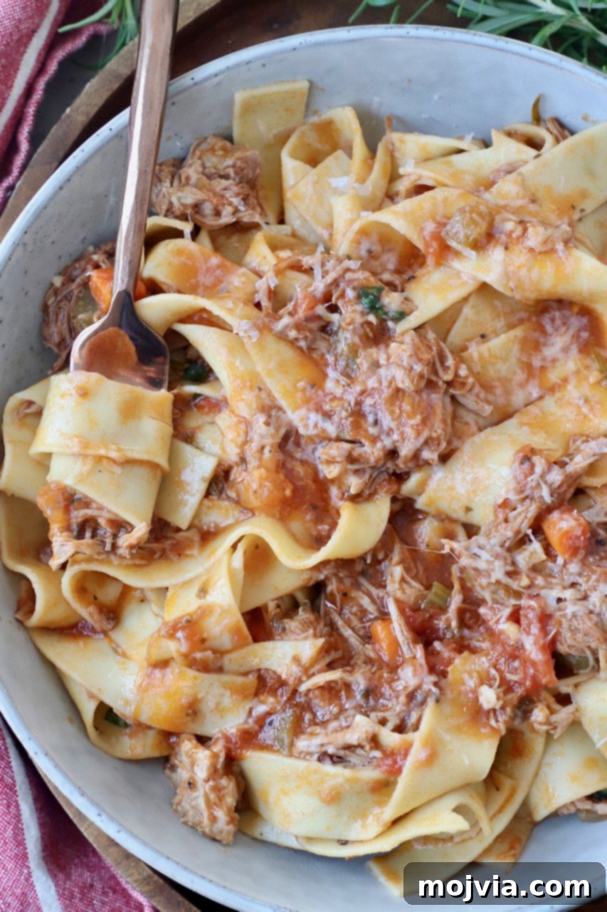 Braised Pork Ragu 10 pappardelle pasta tossed with pork ragu in bowl with fork
