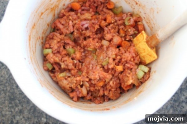 Buffalo chicken meatloaf mixture in a large mixing bowl, ready to be shaped and baked.