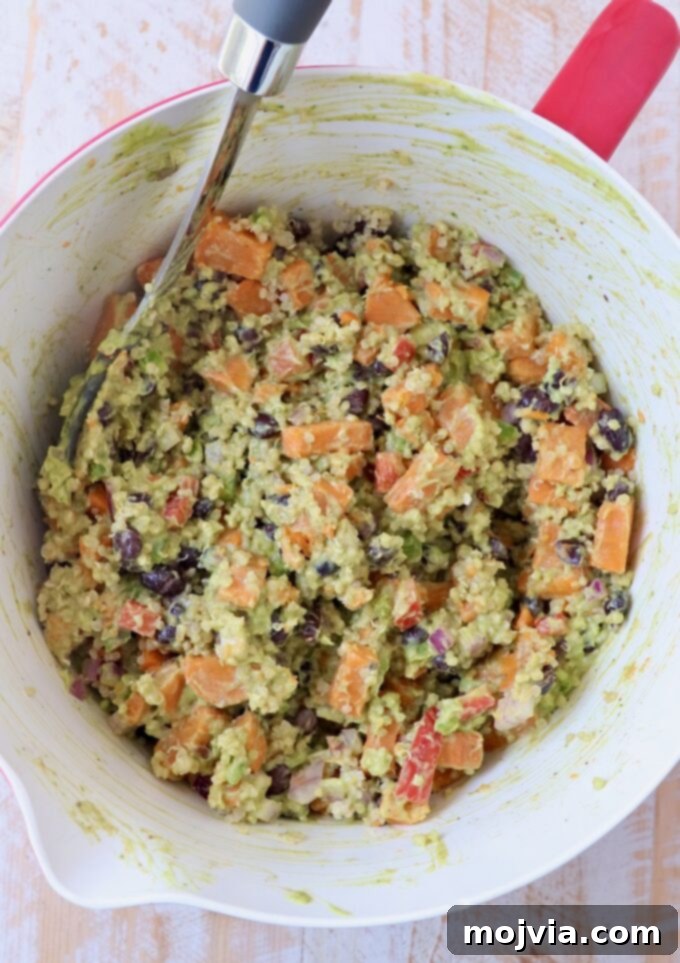 Fiesta Sweet Potato Salad 5 Mexican Sweet Potato Salad gently mixed in a large bowl, fully coated with the creamy avocado dressing.