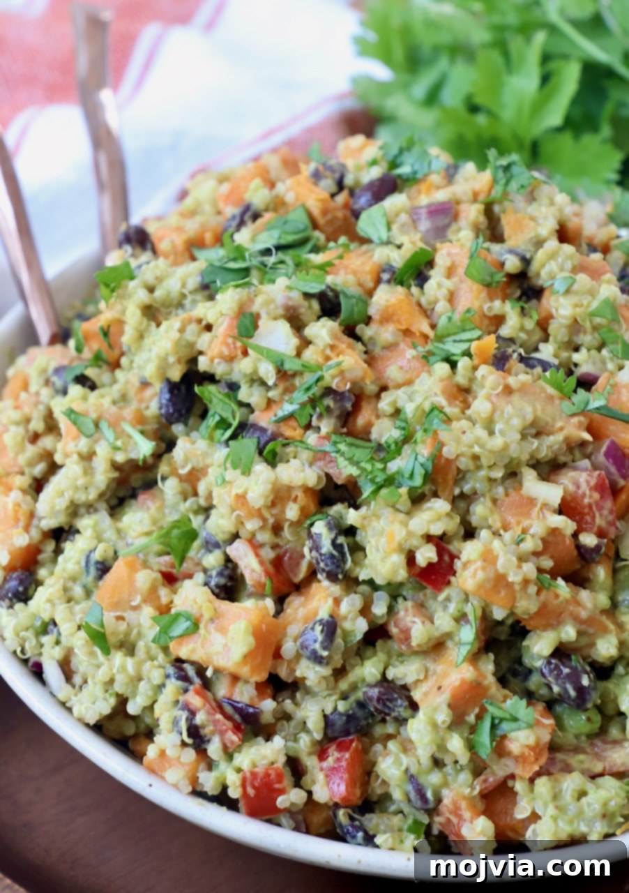 Fiesta Sweet Potato Salad 7 Mexican Sweet Potato Salad with quinoa and black beans served in a bowl with two forks, ready for sharing.