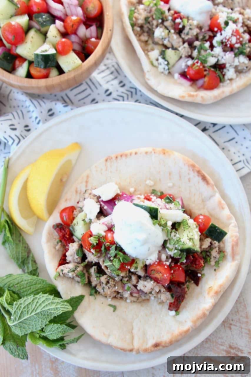 Mediterranean Turkey Gyros 3 Warm pita bread filled with savory ground turkey and fresh salsa, generously topped with creamy tzatziki sauce.