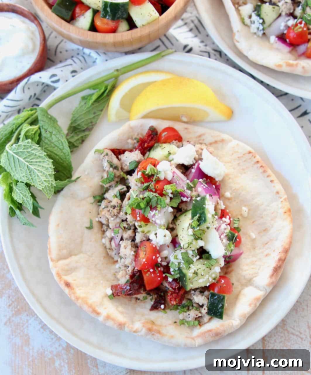 Mediterranean Turkey Gyros 4 Close-up of a flavorful ground turkey Greek taco in pita bread, showcasing the vibrant cucumber tomato salsa.