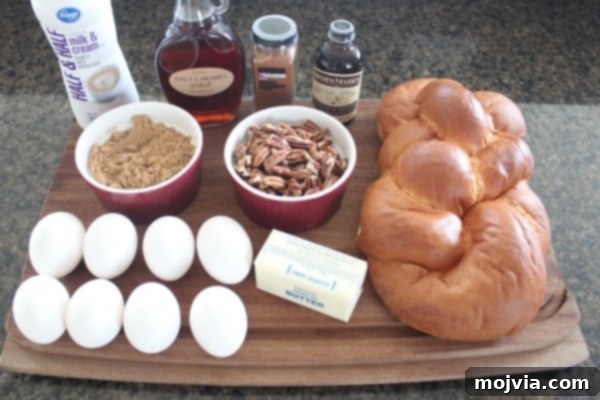 Decadent Salted Caramel Praline French Toast 3 Salted Caramel Praline French Toast Ingredients laid out on a wooden cutting board, showcasing challah bread, eggs, half and half, caramel syrup, cinnamon, brown sugar, butter, and pecans.