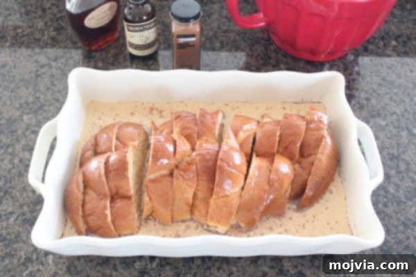 Decadent Salted Caramel Praline French Toast 6 Slices of challah bread fully immersed and soaking in the rich milk and egg mixture in a casserole dish, covered and chilling.