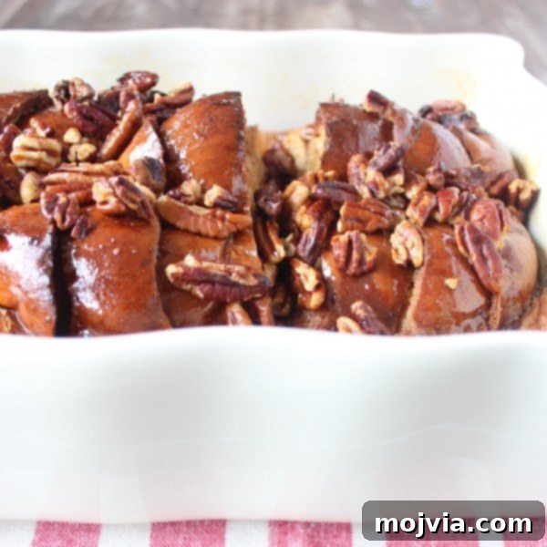 Decadent Salted Caramel Praline French Toast 9 A tempting side view of the baked Salted Caramel Praline French Toast Casserole, showcasing its golden crust and delicious topping.