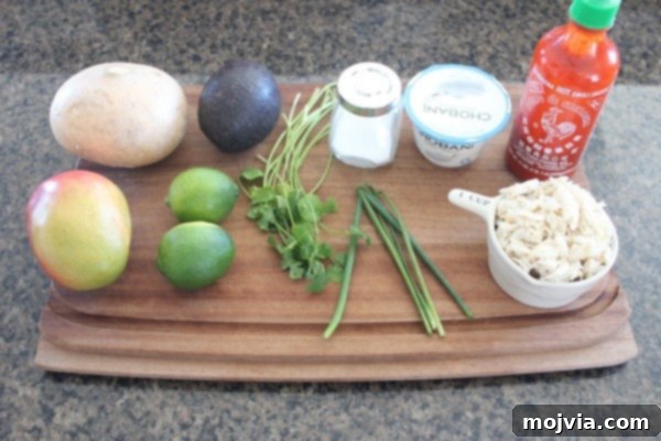 Crisp Jicama Crab Tacos 4 All the fresh ingredients for Jicama Crab Tacos laid out on a table - crab, jicama, mango, avocado, chives, cilantro, limes