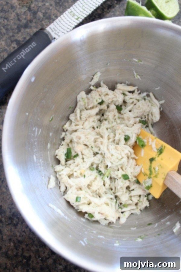Crisp Jicama Crab Tacos 5 Preparing the crab mixture with lime juice and chives for the tacos in a white bowl