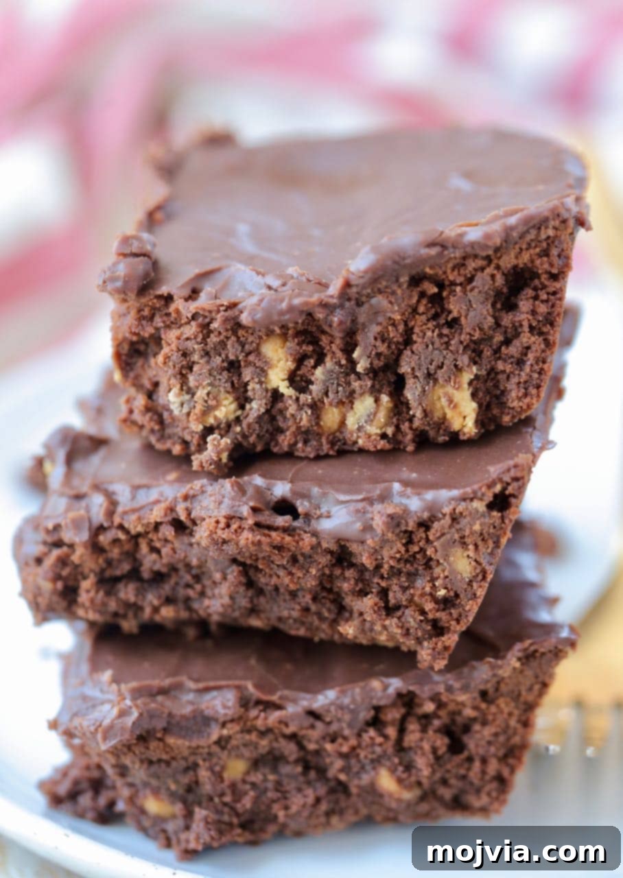 Stack of three double chocolate brownies on plate