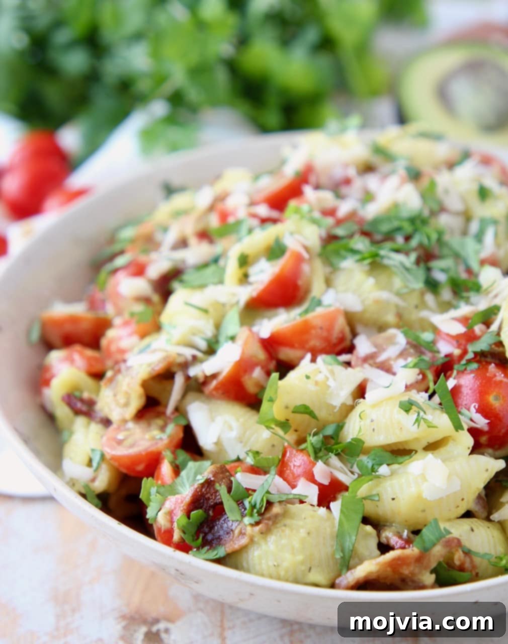 Blissful Bacon Avocado Pasta Salad 2 Pasta salad in bowl with bacon, tomatoes and parmesan cheese