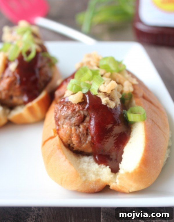 Smoky BBQ Meatball Hero 9 Two hands holding a grilled BBQ meatball sub