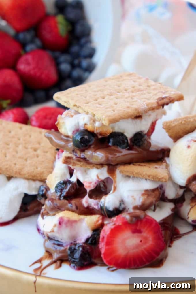 Smores with berries, stacked on top of each other on a white plate