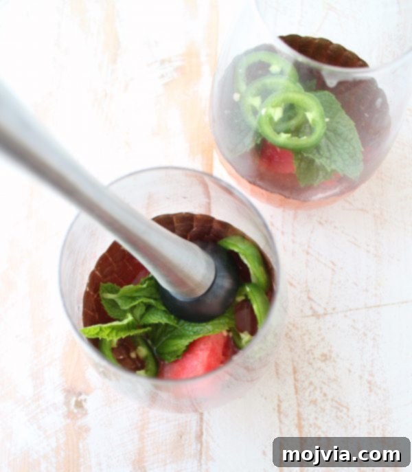 Crimson Kick Mojito 6 Muddled ingredients in a glass for a Watermelon Jalapeno Mojito