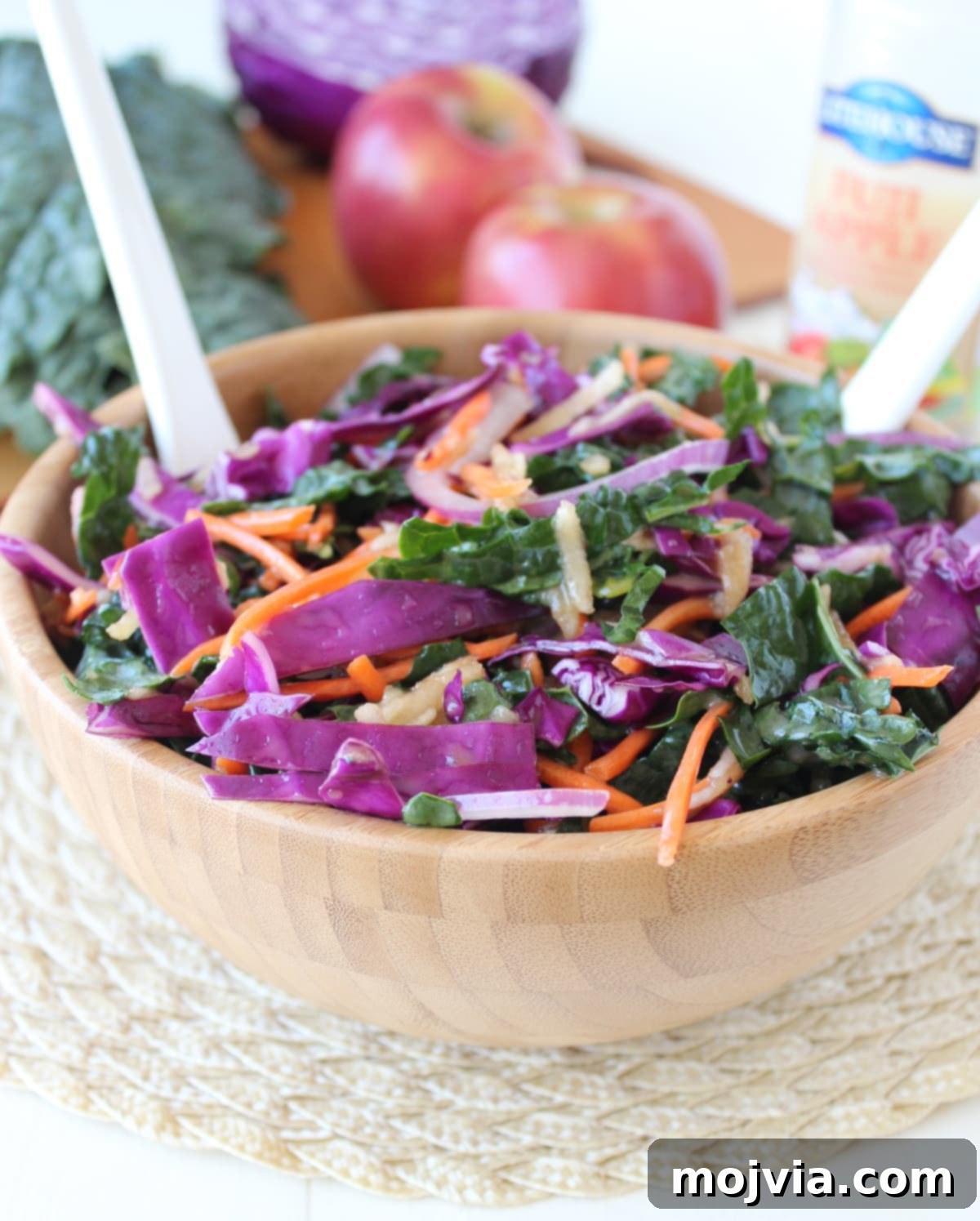 Crisp Kale and Apple Slaw 5 A close-up shot of Kale Apple Slaw served in a white bowl, garnished and ready to eat.