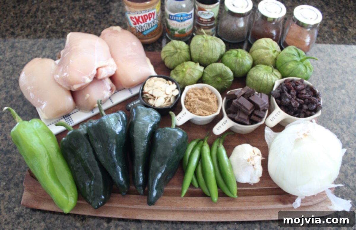 Deeply Flavorful Slow Cooker Chicken Mole 3 A selection of fresh ingredients including tomatillos, various chiles, onions, and spices laid out on a wooden board, ready for Slow Cooker Chicken Mole preparation.