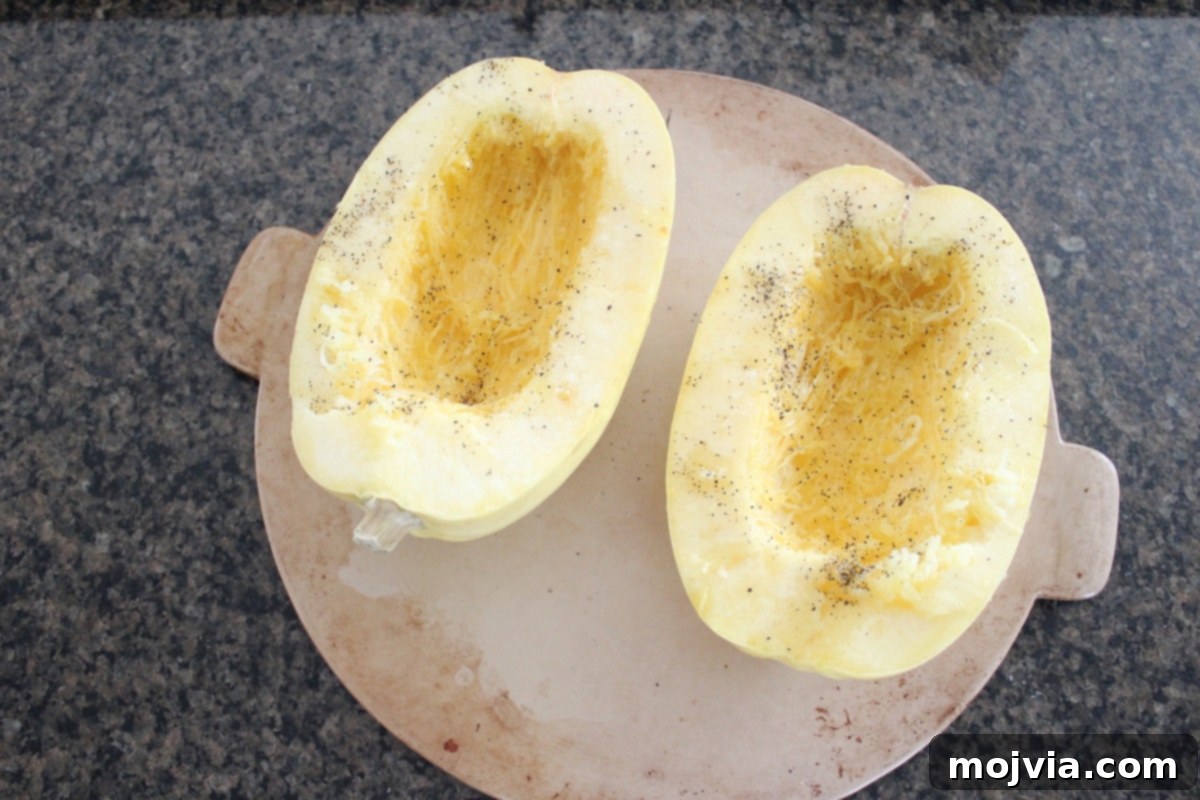 Turkey Chili Spaghetti Squash Bowls 4 Spaghetti squash halves prepared for roasting on a baking sheet