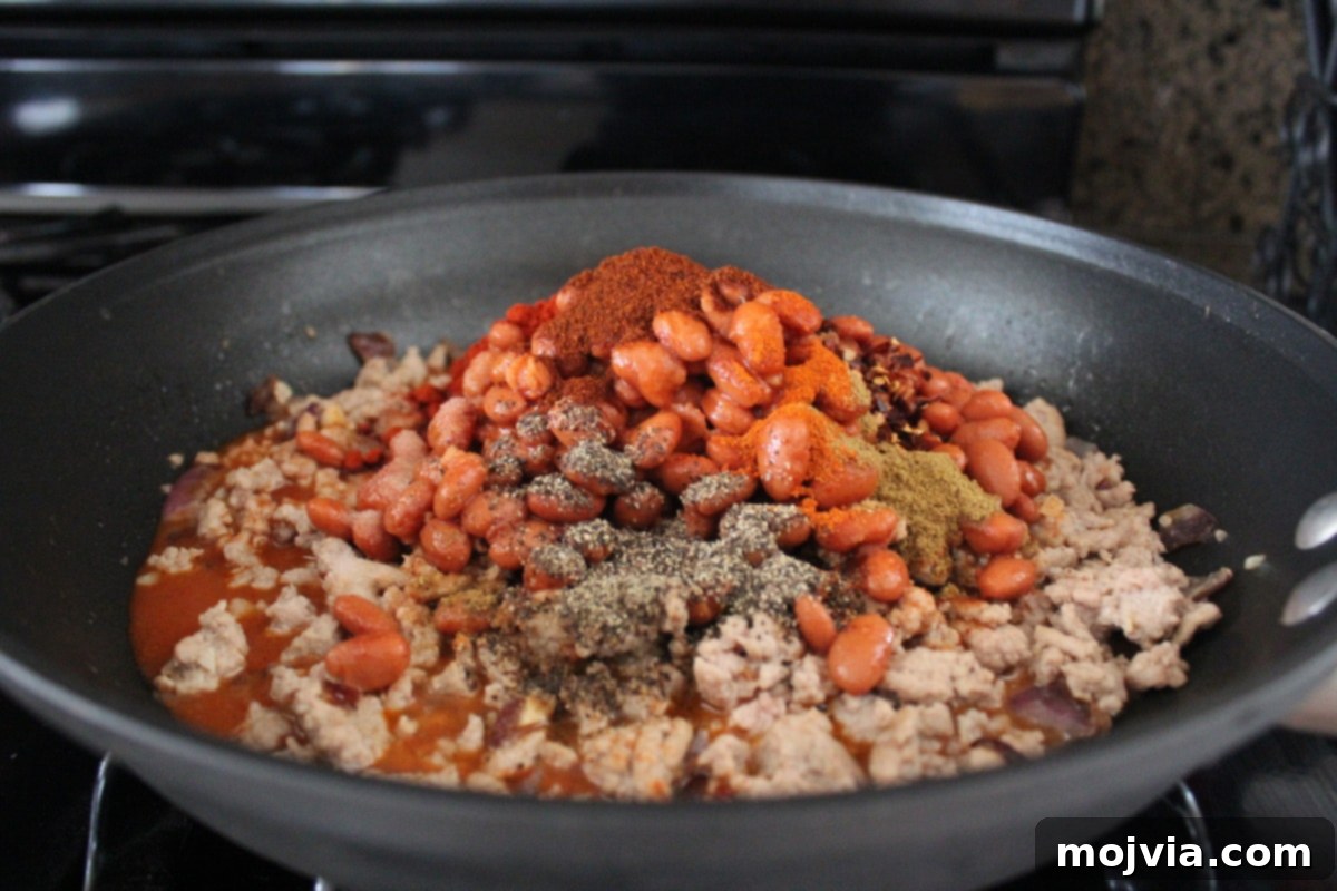 Turkey Chili Spaghetti Squash Bowls 5 Ground turkey browning in a skillet with onions and garlic for chili