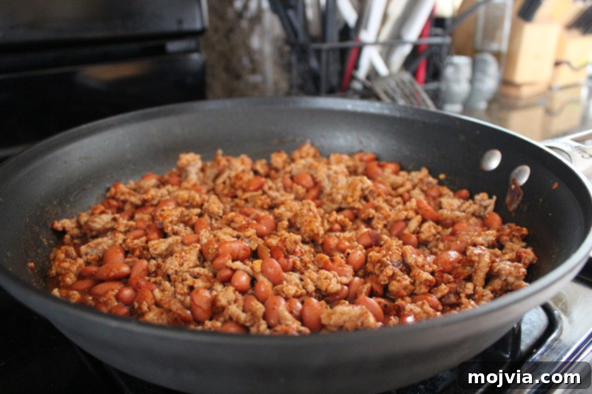 Turkey Chili Spaghetti Squash Bowls 6 Turkey chili simmering on the stove in a large skillet