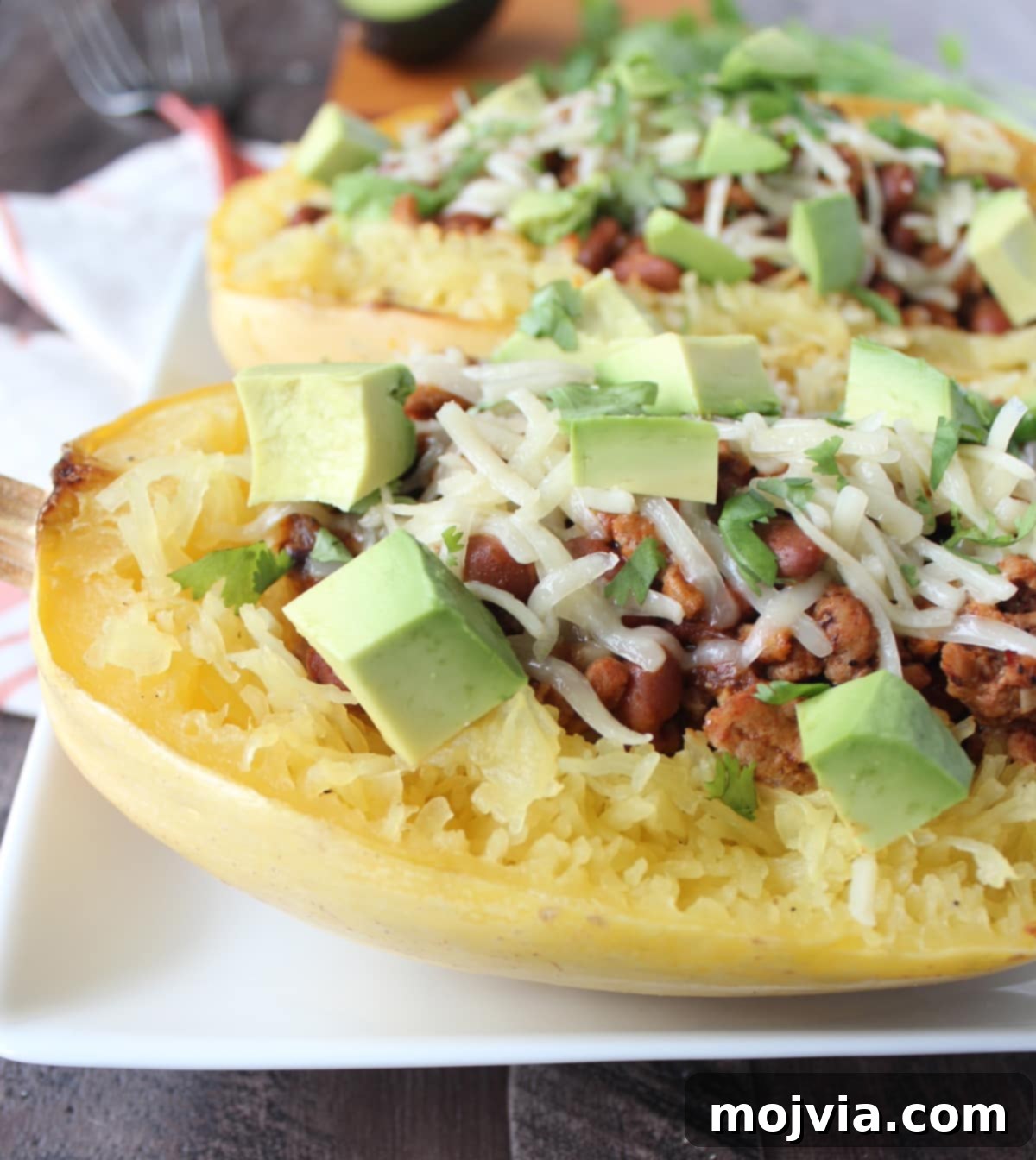 Turkey Chili Spaghetti Squash Bowls 8 Finished Turkey Chili Spaghetti Squash dish garnished with cilantro and avocado