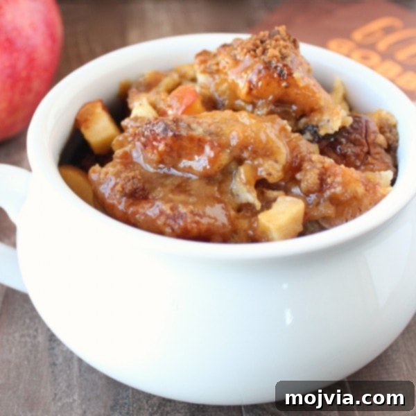 baked bread pudding in white bowl topped with caramel sauce