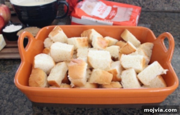 cubed bread in orange baking dish
