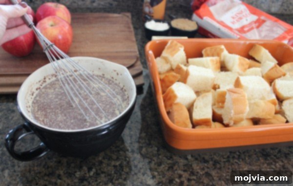 milk eggs and cinnamon mixed together in bowl with whisk