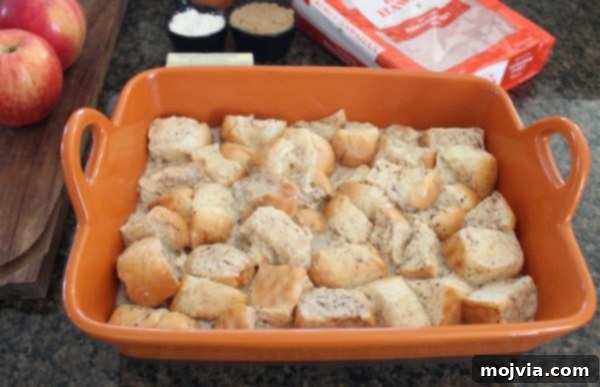 unbaked bread pudding in orange baking dish