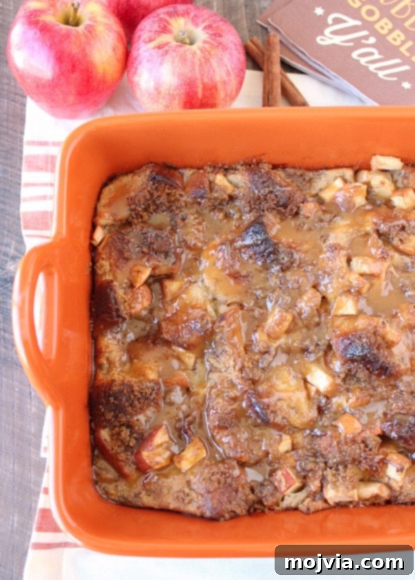 baked bread pudding topped with caramel sauce in orange baking dish