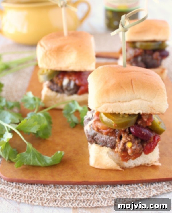 Spiced Pumpkin Chili Sliders 3 Close-up shot of Pumpkin Chili Sliders with melted cheese and fresh toppings