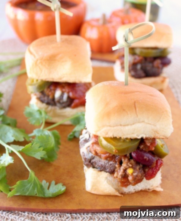 Spiced Pumpkin Chili Sliders 8 Finished Pumpkin Chili Sliders with various toppings, ready for serving