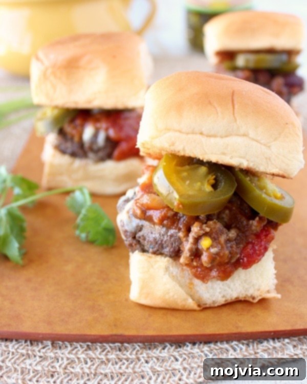 Spiced Pumpkin Chili Sliders 9 A close-up of a Pumpkin Chili Slider, highlighting the chili, cheese, and bun