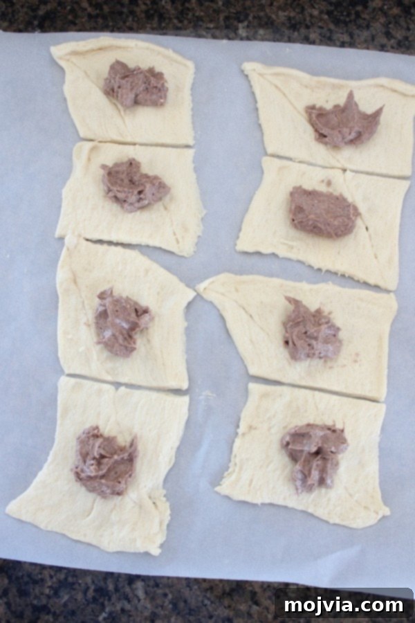 Creamy Apple Cinnamon Danish Delight 8 Crescent dough squares topped with a spoonful of cream cheese filling