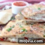 calzone cut in half on wood serving tray