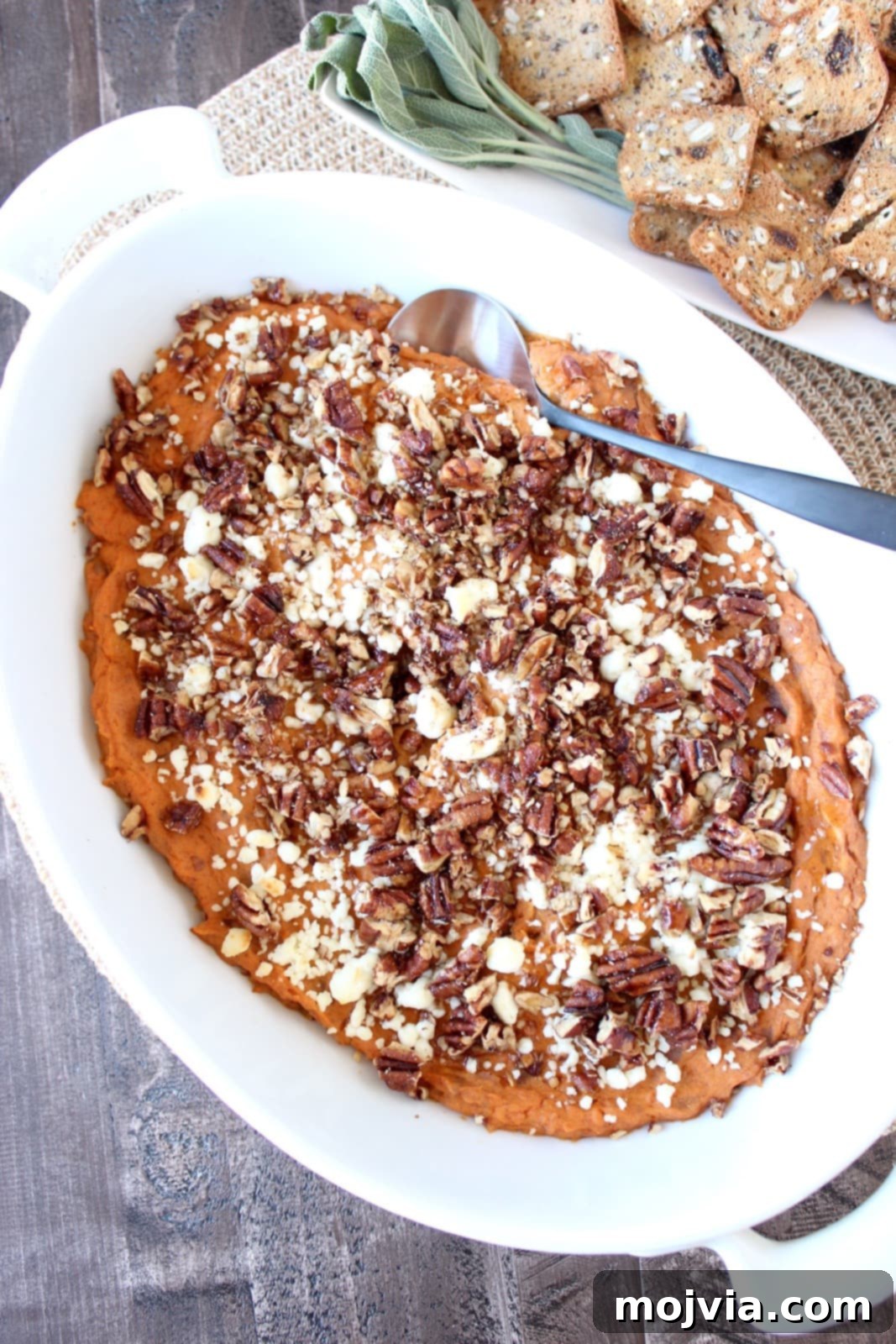 Creamy Sweet Potato & Three Cheese Dip Recipe, garnished with pecans and maple syrup