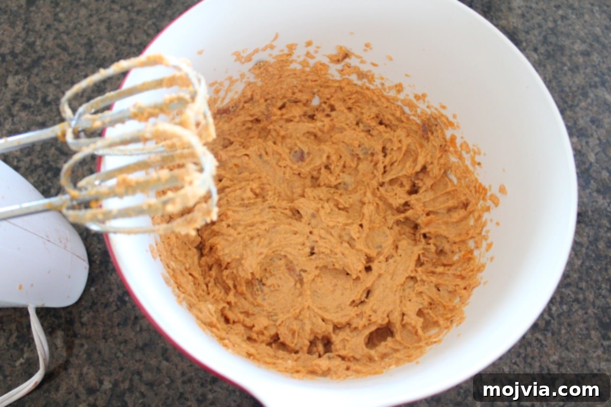 The blended sweet potato and cheese dip mixture in a bowl, ready for baking.