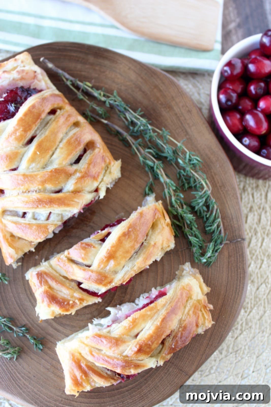 Golden Cranberry Turkey Puffs 3 Freshly roasted turkey slices alongside a bowl of vibrant cranberry jalapeno relish, highlighting the key components for the puff pastry recipe.