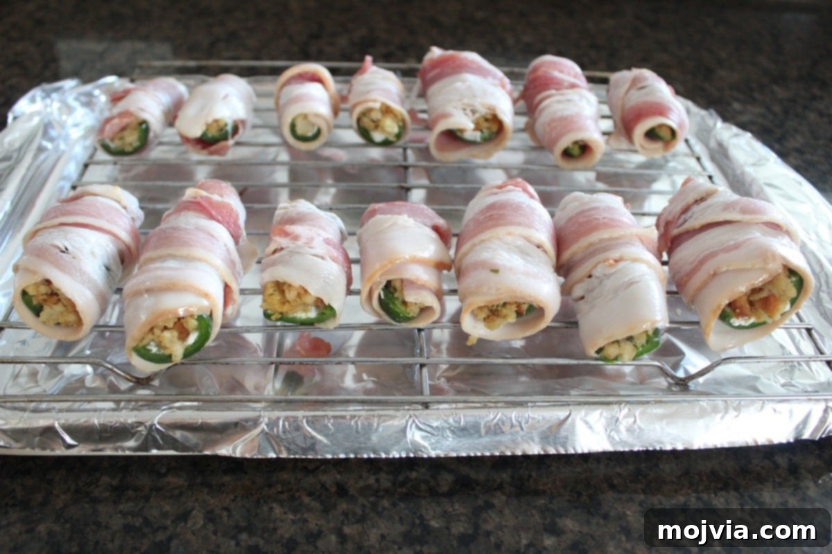 Explosive Cream Cheese Jalapeno Bites 8 Wrapping each stuffed jalapeno with a slice of bacon.