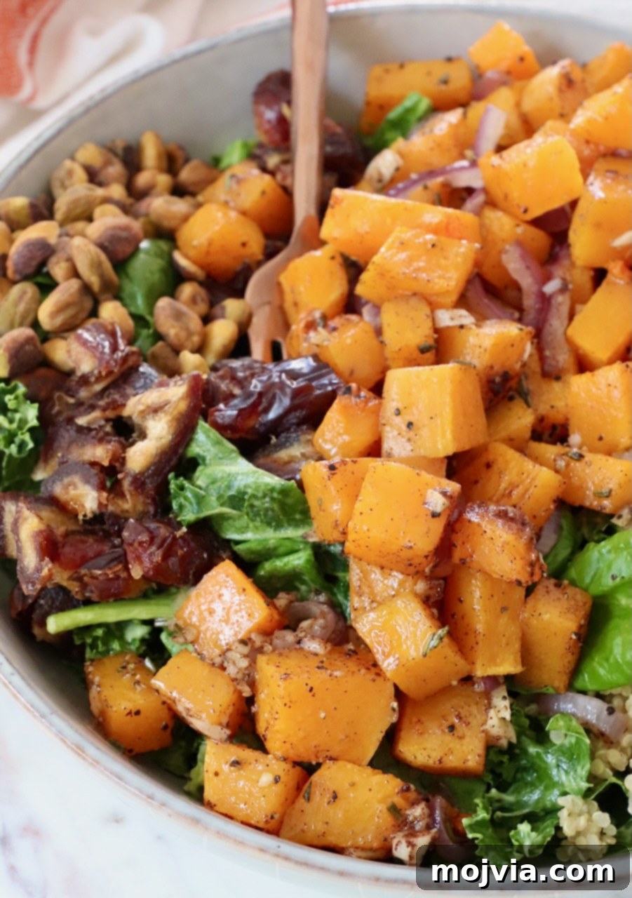 Golden Roasted Butternut Salad 9 roasted butternut squash on top of a salad in a bowl