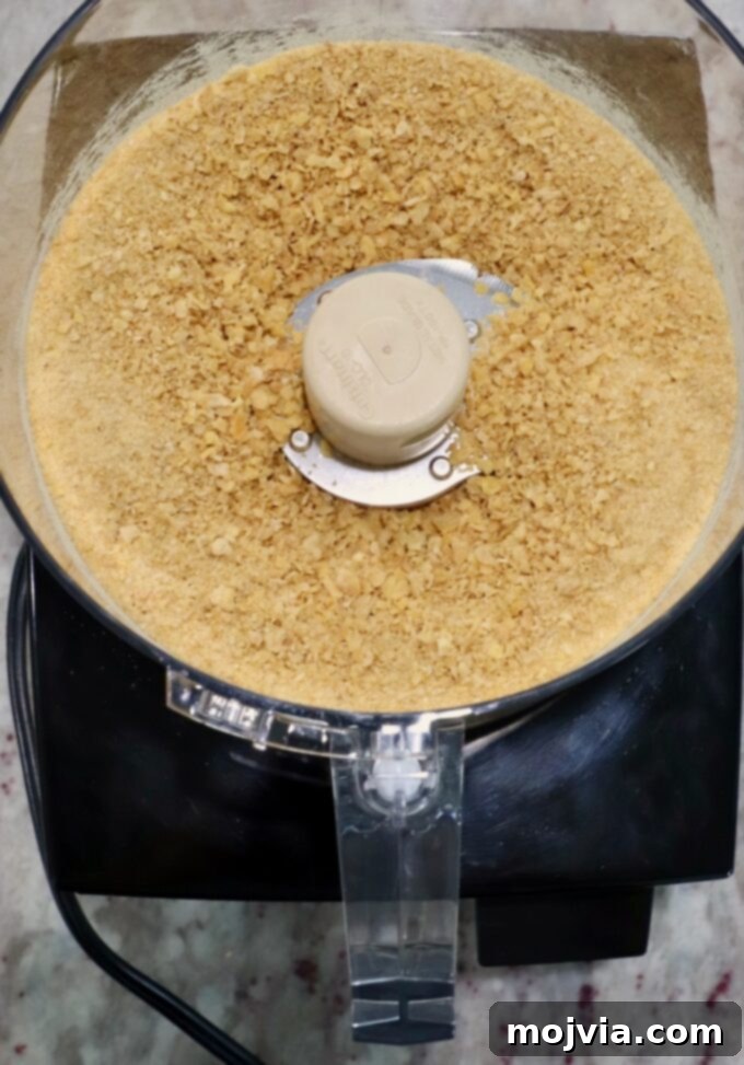 Sweet Heat Chipotle Chicken Tenders 4 Crushed corn flakes cereal in a food processor, ready for breading.