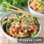 Thai peanut noodles in bowl with chopsticks on the side