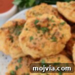cheddar biscuits stacked up on a plate
