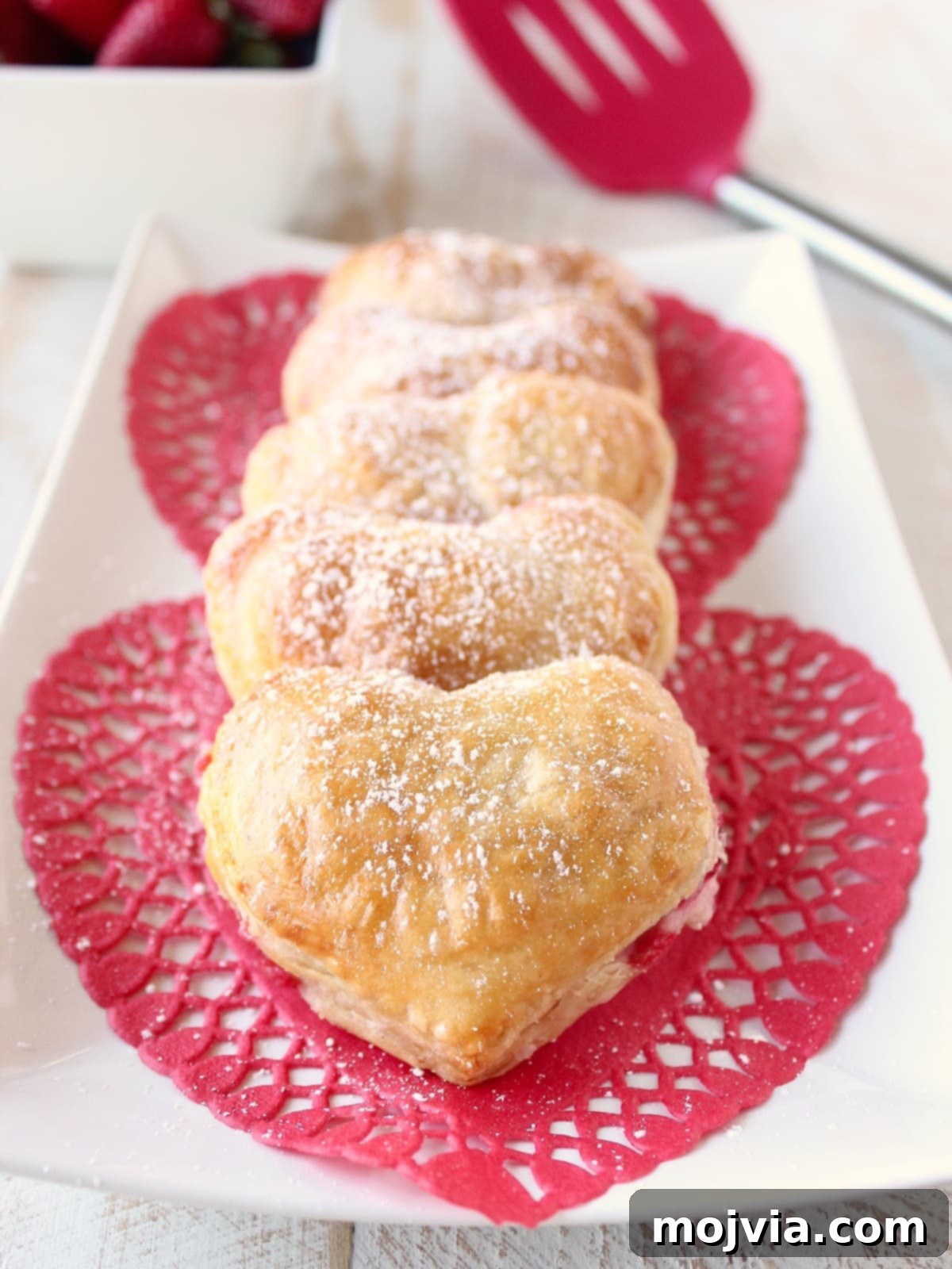 Strawberry Cheesecake Puff Pastry Hearts 14 Close-up of a Heart Shaped Strawberry Cheesecake Puff Pastry Pie dusted with powdered sugar
