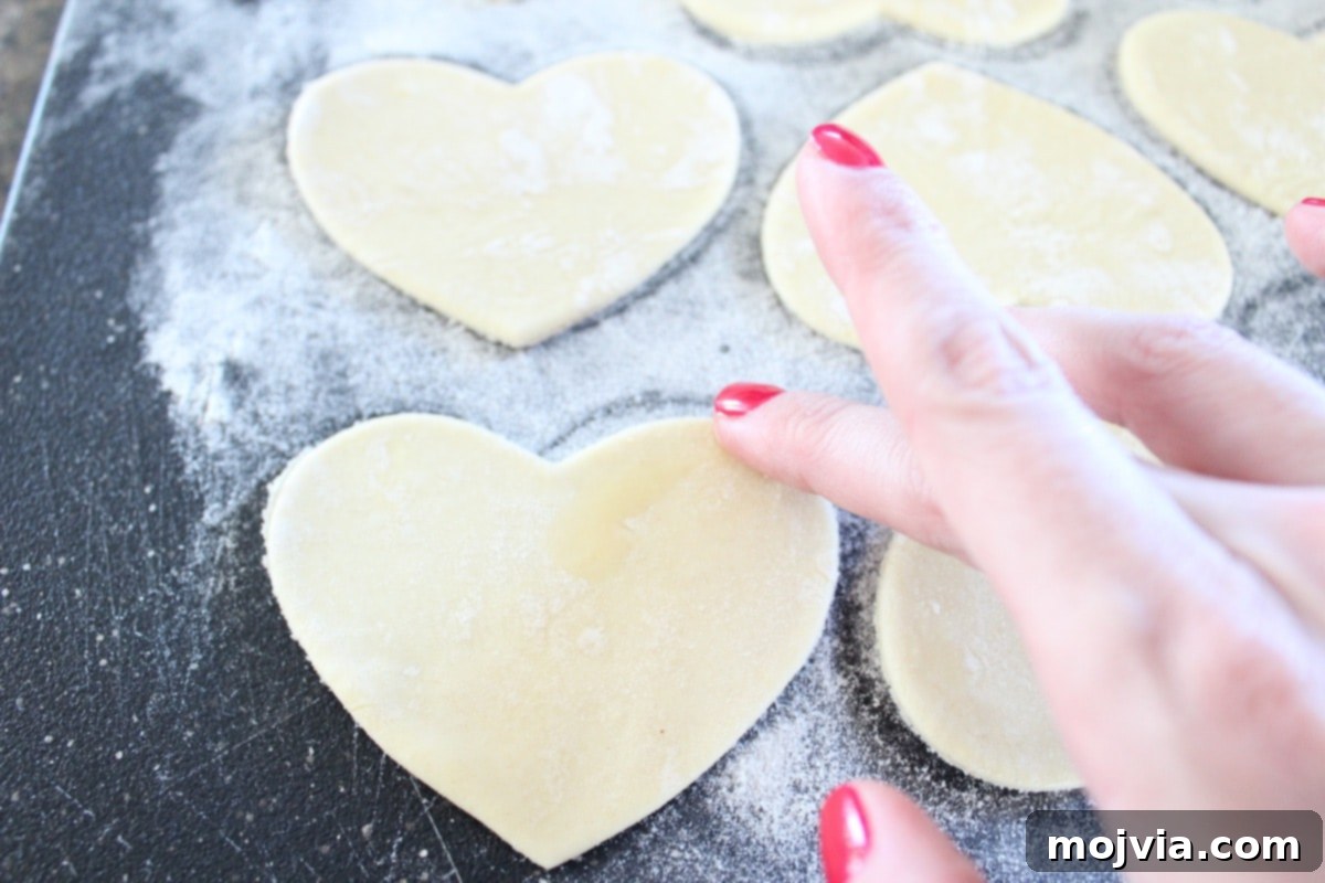 Strawberry Cheesecake Puff Pastry Hearts 8 Brushing the edges of puff pastry hearts with egg wash